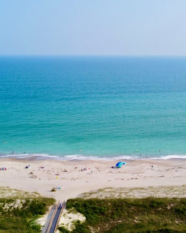 Aerial view of Emerald Isle NC beach with turquoise water and wide sandy shoreline