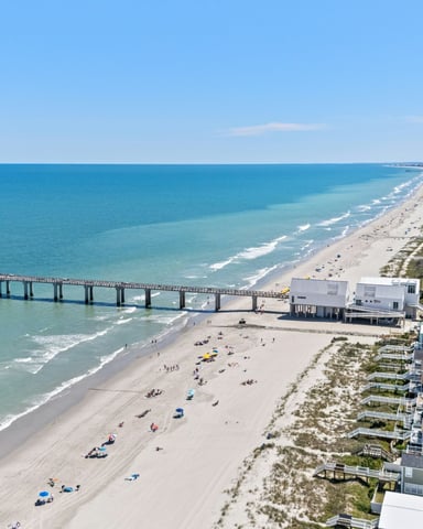 Aerial view of Surfside Beach SC fishing pier with condos and beach stretching into the distance
